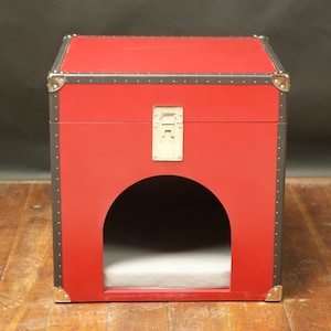 Red doghouse or cathouse like a trunk