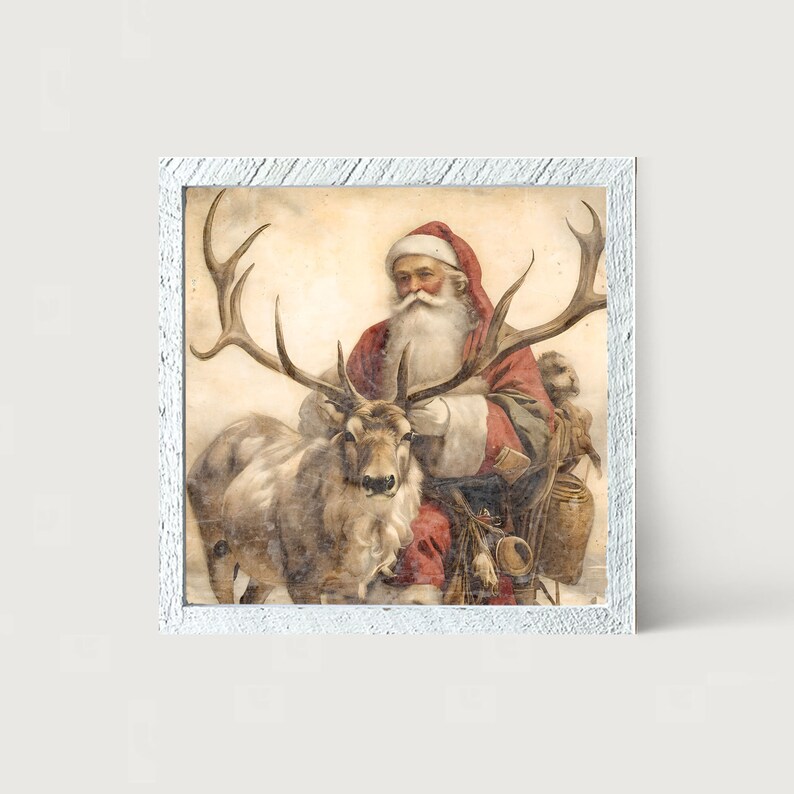 May include: A framed print featuring Santa Claus with a reindeer. Santa is dressed in a red suit and hat, with a long white beard. The reindeer has large antlers. The frame is white with a distressed finish. The artwork has a vintage aesthetic.