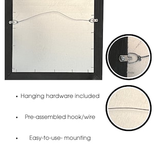 May include: Back of a framed artwork with a black wooden frame. The back features a silver canvas and a pre-assembled wire for hanging. Hanging hardware is included, and the mounting is easy to use.