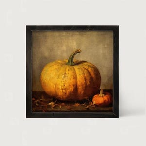 May include: A square framed oil painting depicting a large, textured orange pumpkin alongside a smaller, round orange pumpkin. The pumpkins feature visible green stems and are set against a muted, neutral-toned background with dark shadows.