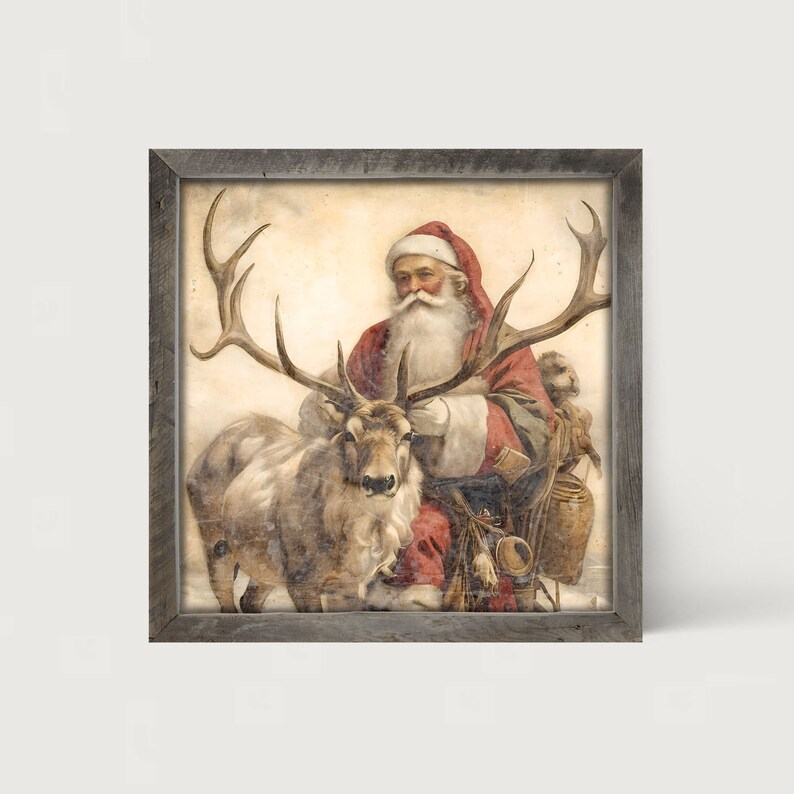 May include: A framed vintage print depicts Santa Claus in a red suit and hat, seated next to a reindeer with large antlers. The artwork has a rustic, aged appearance, with a neutral background and a weathered gray frame. The image evokes a classic Christmas theme.