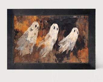May include: A rectangular framed painting featuring three off-white ghost figures with dark eyes against a textured, abstract background of deep brown, black, and burnt orange tones. The artwork is enclosed in a simple, dark-stained wooden frame.