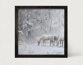 May include: A square wall art piece featuring a snowy forest scene with three white horses grazing. The painting is rendered in shades of white, gray, and black, framed in dark wood, and includes small integrated warm yellow LED lights.