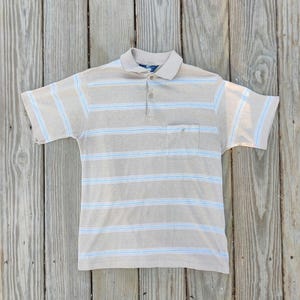 May include: Tan polo shirt with horizontal blue and white stripes. The shirt has a collar, a three-button placket, and a chest pocket. The short-sleeved shirt is made of a soft, breathable fabric, perfect for casual wear.