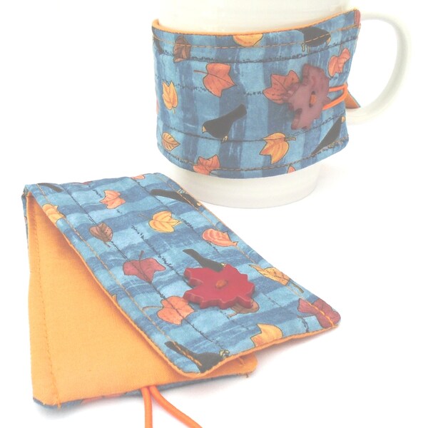 Wrap around mug cozies - set of 2 - black crows with gold brown orange autumn leaves on blue.