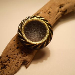 BUTTONS:  Brown and gold round button with notched surface. Vintage.