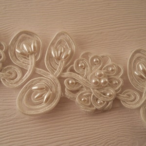 TRIM:  White bridal trim, corded, pearled.  1 1/2 inches wide.  One yard.