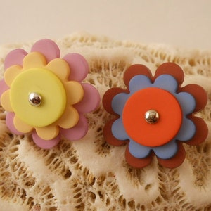 BUTTONS:  Flower buttons made with three pieces, pink or burgundy colors, child's button. 3/4 inch size.