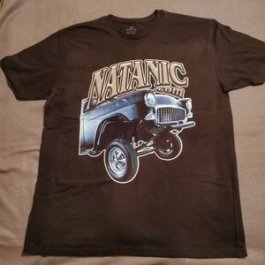 May include: A black t-shirt with a graphic of a vintage car and the text "NATANIC.com" printed on the front.