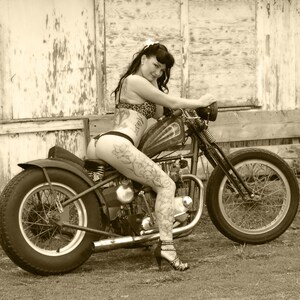 8x10 inch photo of a tattooed babe on a Triumph bobber motorcycle