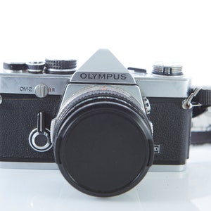 Film camera Olympus OM-2. Lens Olympus OM-System Zuiko Auto-S 50mm f/1.8. Working Film camera.