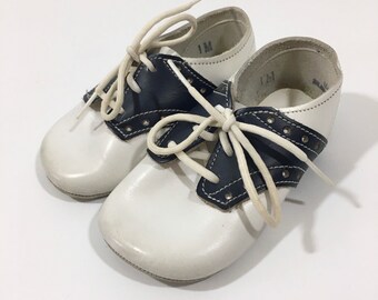 navy blue and white saddle shoes