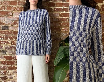 May include: A blue and white striped sweater with a checkered pattern. The sweater is made of a soft, knit fabric.