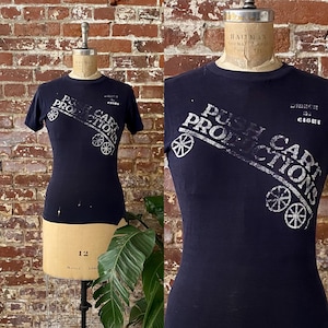 1970年代のヴィンテージ プッシュカートプロダクションズ 色褪せTシャツ - レイス「トルソーTシャツ」サイドシームとウエスト変更 - シングルステッチ - Sサイズ *現状渡し