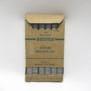 May include: A package of Bostitch STCR 5019-1/2" staples. The cardboard box is tan with green text and a flap at the top. The text on the box reads "1000 Genuine Bostitch Staples STCR 5019-1/2" For use in Bostitch T5-8 Tacker."