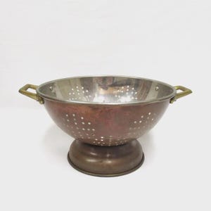 May include: A set of three ceramic mugs with a speckled, matte finish. The mugs are in shades of cream, light gray, and dark gray. Each mug has a simple, modern design and a rounded handle.