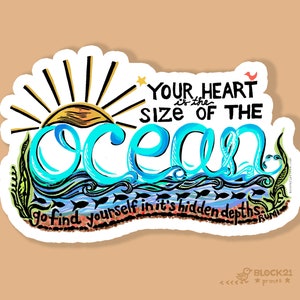 May include: A sticker with a hand-drawn design featuring the text "Your heart is the size of the ocean." The word "ocean" is in blue, stylized script. The design includes a sun, waves, fish, and the quote "go find yourself in it's hidden depths."