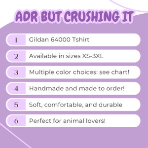 May include: A purple and white graphic with the text "ADR BUT CRUSHING IT" at the top.  The graphic lists six features of a Gildan 64000 T-shirt, including that it is available in sizes XS-3XL, comes in multiple colors, is handmade to order, and is soft, comfortable, and durable.