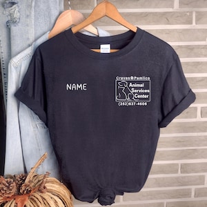 May include: Black t-shirt with a white graphic of a dog and the text "Craven Pamlico Animal Services Center (252) 637-4606". The text "NAME" is printed on the shirt.