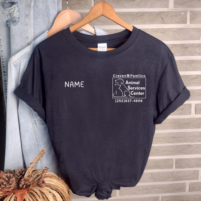 May include: Black t-shirt with a white graphic of a dog and the text "Craven Pamlico Animal Services Center (252) 637-4606". The text "NAME" is printed on the shirt.