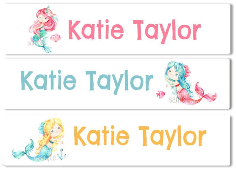 May include: Three white labels with a mermaid illustration and the name "Katie Taylor" printed in pink, blue, and orange text.