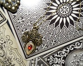 DOOR-KNOCKER Braided Human Hair and Red Jewel Rose Bronze Pendant Necklace