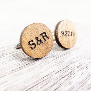 May include: A pair of wooden cufflinks with engraved initials "S&R" and the date "9.27.19".