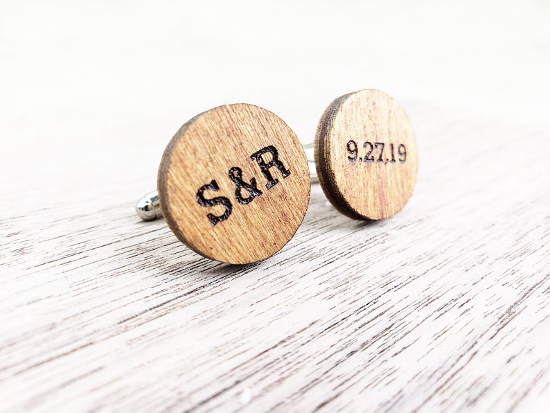 May include: A pair of wooden cufflinks with engraved initials "S&R" and the date "9.27.19".