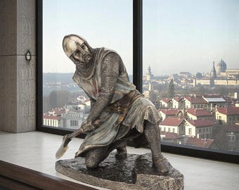 May include: A bronze-toned statue of a kneeling knight in full armor, holding a weapon. The knight wears a helmet, chainmail, and a tunic with a red cross. The statue is on a stone base, set against a cityscape background.