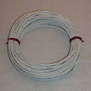 May include: A roll of white paper cord, tied with a burgundy ribbon. The cord is twisted and has a rough texture.