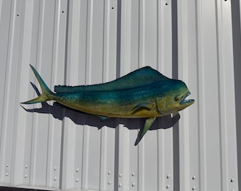 May include: A wall-mounted mahi-mahi fish replica featuring a vibrant gradient of deep blue along the dorsal fin and upper body, transitioning into a bright yellow hue on the lower belly and tail, with a realistic open-mouthed expression.