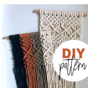 May include: Two macrame wall hangings, one with a white cord and one with black, orange, and brown cords. The hangings are made with a diamond pattern and have fringe at the bottom. The image includes the text "DIY pattern" and "Make your own macrame wall hanging".