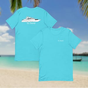 May include: Two turquoise t-shirts. One features a yacht graphic with the text "St. David" on the back. The other shirt has "St. David" printed on the front. The shirts are short-sleeved and made of a soft material.