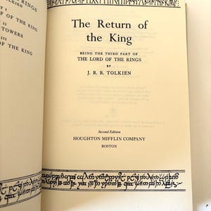 May include: Open book with the title "The Return of the King" by J.R.R. Tolkien. The book is a second edition published by Houghton Mifflin Company in Boston. Decorative border in a stylized font.