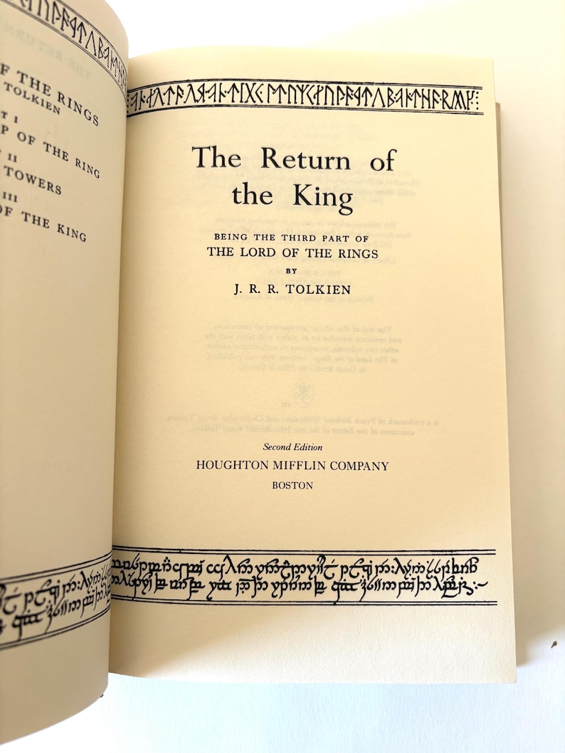 May include: Open book with the title "The Return of the King" by J.R.R. Tolkien. The book is a second edition published by Houghton Mifflin Company in Boston. Decorative border in a stylized font.