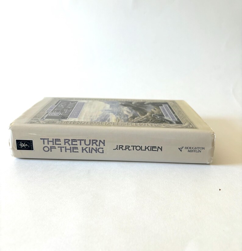 May include: A hardcover book titled "The Return of the King" by J.R.R. Tolkien. The book has a cream-colored cover with the title in dark blue and a detailed illustration. The publisher's logo is visible.