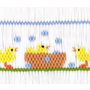 May include: Embroidered fabric featuring a row of yellow chicks with orange feet and beaks. One chick is in a brown basket with blue bubbles. Pink flowers and green grass are below the chicks. A blue line is at the top.