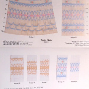 May include: A page from "The Designer Collection" featuring embroidery designs. The designs include blue, pink, and beige patterns. The text includes "Emily Claire 010011" and D.M.C. color codes. The designs are for fabric work.