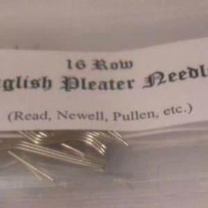 May include: A package of English Pleater Needles, with the text "16 Row English Pleater Needles (Read, Newell, Pullen, etc.)". The needles are silver-colored and appear to be made of metal. The package is clear.