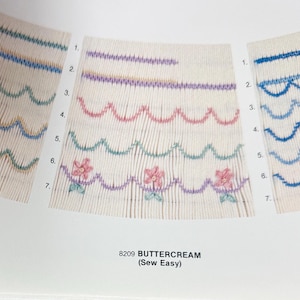 May include: Three fabric samples showcasing various embroidered stitch patterns. The samples feature rows of decorative stitches in blue, purple, pink, and green. The text "8209 BUTTERCREAM (Sew Easy)" is visible.