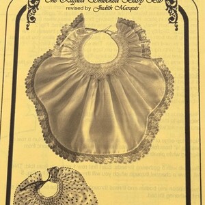 Ruffled Smocked Baby Bib.  NEW Smocking Plate designed by A Garden of Smocking Designs Judith Marquis