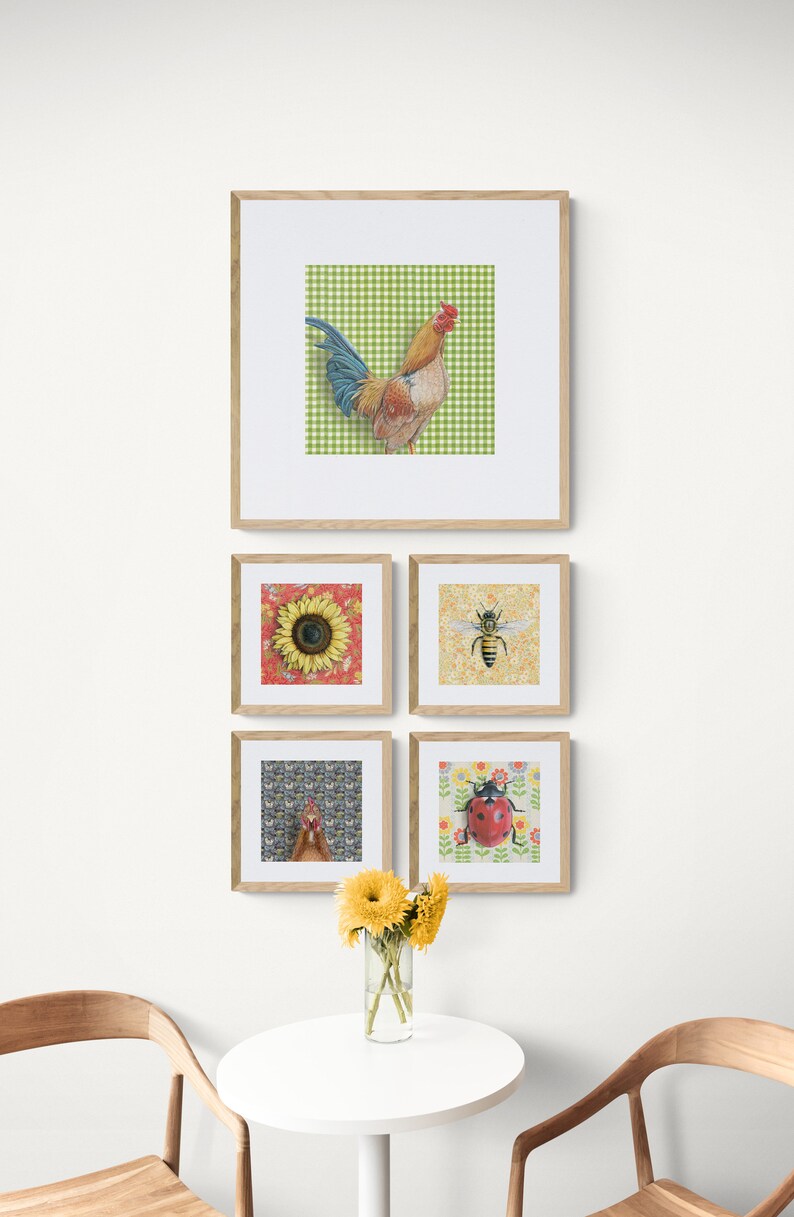 May include: Five framed prints with different animal and floral designs. The prints are arranged in a grid pattern on a white wall. The top print features a rooster on a green and white checkered background. The other prints feature a sunflower, a bee, a hen, and a ladybug.