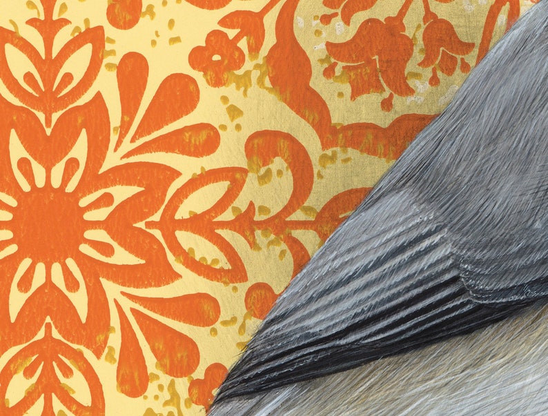 May include: A close-up of a patterned wallpaper with orange and yellow floral designs. The wallpaper is partially covered by a piece of gray textured material.