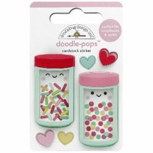 May include: Two sticker jars with happy faces, one filled with colorful sprinkles and the other with colorful dots. The stickers are on a white background with the text "doodle-pops" and "cardstock sticker".