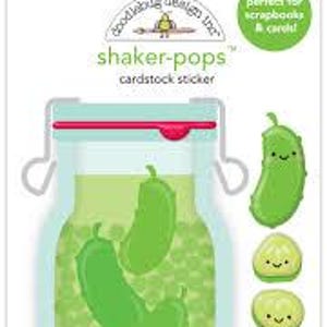 May include: A Doodlebug Design Inc. shaker-pops cardstock sticker set featuring a light blue mason jar filled with green pickles and peas. The set includes a large jar sticker and four smaller individual pickle and pickle slice stickers with faces.