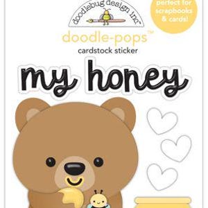 May include: A cardstock sticker sheet featuring a brown bear holding honey, a bee, and a honey pot. The words "my honey" are in black script. The sticker sheet is labeled "doodle-pops" and is perfect for scrapbooks and cards.