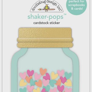 May include: A cardstock sticker pack featuring a jar design with colorful heart-shaped confetti. The jar has a gold lid and a light blue outline. The text "shaker-pops" and "cardstock sticker" are visible.