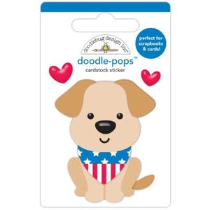 May include: A cardstock sticker featuring a cartoon dog with tan fur, brown ears, and a black nose. The dog wears a blue and red bandana with stars and stripes. The sticker is labeled "doodle-pops" and includes two red heart accents.