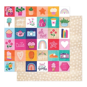 May include: A colorful scrapbook paper sheet with a grid of illustrated squares. The squares feature images of cupcakes, rainbows, flowers, and text like "cute" and "read more books". The background is a light wood grain with white polka dots.