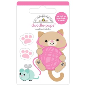 May include: A set of doodle-pops cardstock stickers featuring a brown cat holding a pink ball of yarn, two pink paw prints, and a teal wind-up mouse. The stickers are on a pink and white background with the text "doodle-pops™ cardstock sticker" and "perfect for scrapbooks & cards!"
